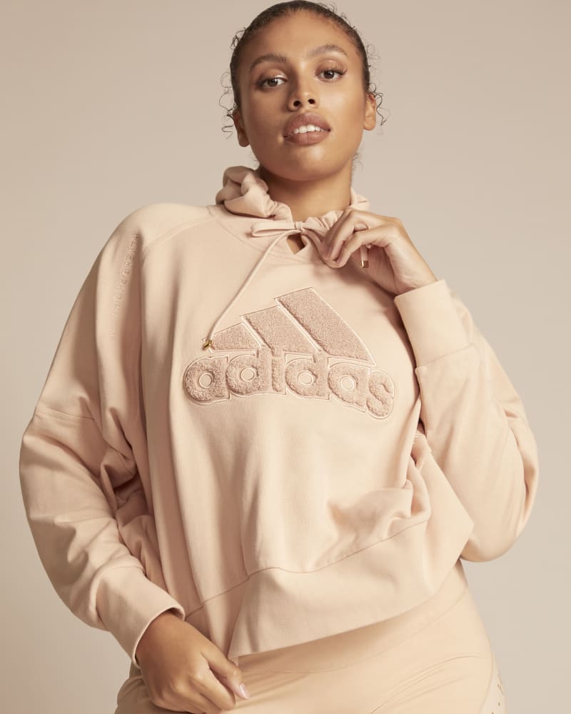 Front of a model wearing a size 1X 11 Honoré x Adidas Hoodie in Pink by Adidas x 11 Honoré. | dia_product_style_image_id:245713